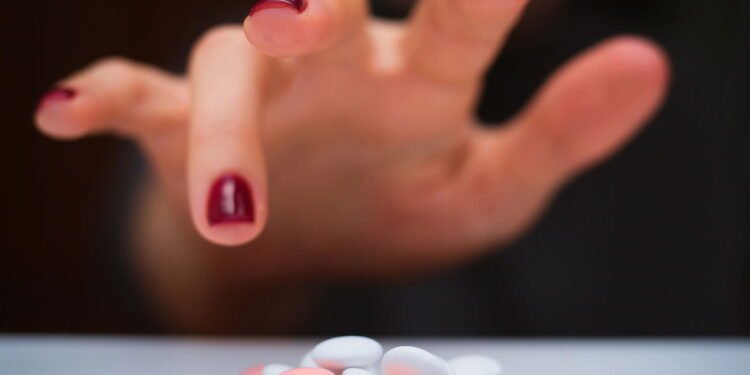 Mão pegando remédios - Créditos: depositphotos.com / Martyna1802