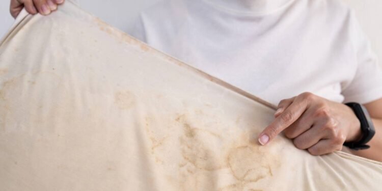 Com o tempo, o acúmulo de suor, óleos corporais e produtos para cabelos pode resultar em manchas amareladas - Créditos: depositphotos.com / Chai2523